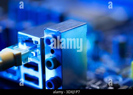 Fiber optic cables connected to optical ports and network cables connected to internet ports Stock Photo