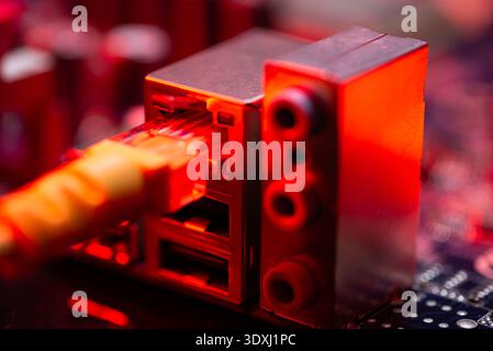 Fiber optic cables connected to optical ports and network cables connected to internet ports Stock Photo