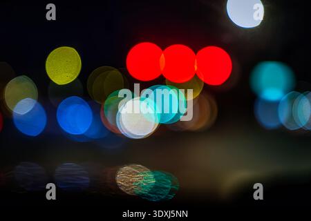 Abstract colorful bokeh lights at night with soft focus and vibrant circles creating a dreamy urban background Stock Photo