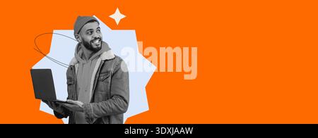 Young Man Using Laptop While Smiling in a Bright Orange Background Stock Photo