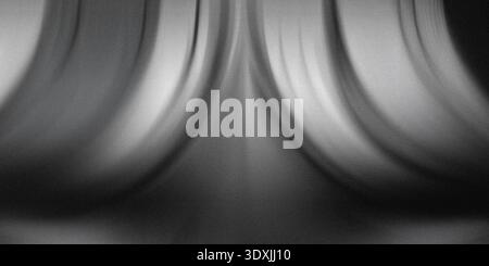 Abstract monochrome image featuring curved metallic structures with blurred motion and soft lighting Stock Photo