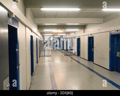Inside of former prison - view to corridor with cell rows for prisoners Stock Photo