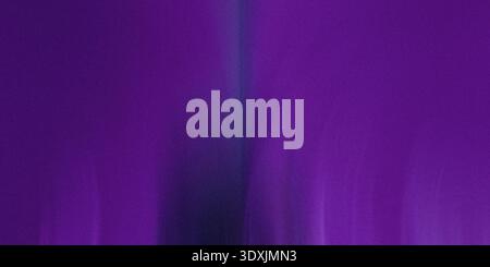 An abstract gradient of purple and dark blue with vertical blur creating a soft and dreamy background Stock Photo