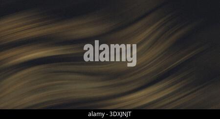 A close up shot showing the texture and patterns of a dark brown and tan colored rock surface formation Stock Photo