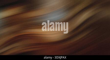 An abstract blurry image with shades of brown and subtle hints of lighter colors creating a soft effect Stock Photo