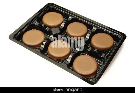 Set of chocolate cake desserts in plastic assorted isolated on white background Stock Photo