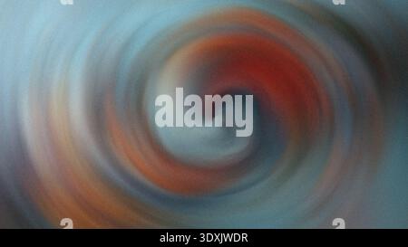 Abstract blurred swirl of colors with red and blue hues creating a dynamic and artistic composition Stock Photo
