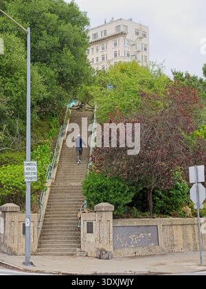 Man climbing stairs into Russian Hill park honoring poet George Sterling in San Francisco Stock Photo