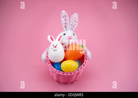 Front view of Easter basket with bunny and colorful eggs. Stock Photo