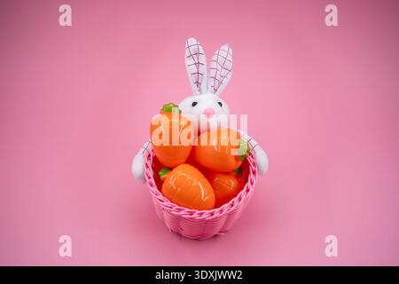 Front view of Easter basket with bunny and carrot decorations. Stock Photo