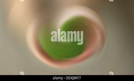 A swirling vortex of green and beige colors creating an abstract and blurred circular pattern design art Stock Photo