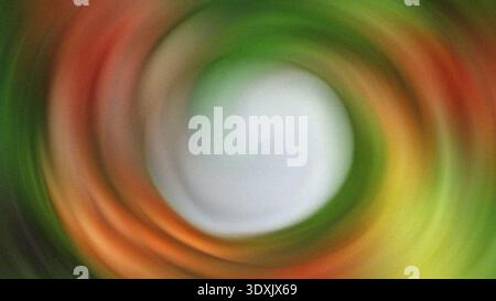 A blurred abstract image featuring a central white orb surrounded by swirling colors of red and green hues Stock Photo