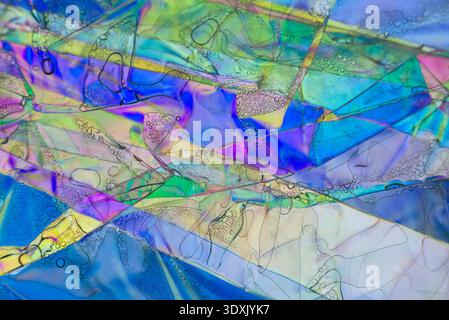 Complex geometric planes and iridescent colors in a microscopy interference pattern. Stock Photo