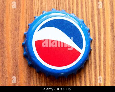 Yerevan, Armenia - January 18, 2026: top view of tin cap from Pepsi bottle closeup on wooden table background Stock Photo