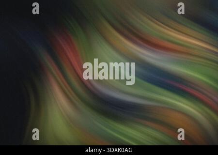 Abstract blurry image featuring shades of green yellow red and black creating a textured background Stock Photo