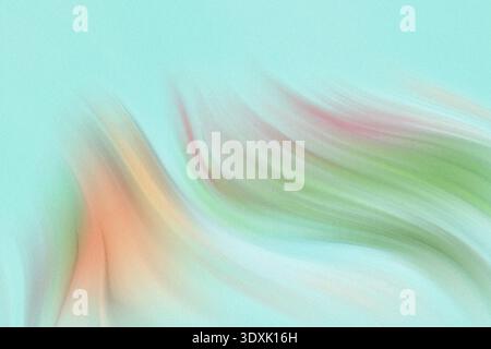 A blurry image showing two hands with an orange object against a light green or blue background color Stock Photo