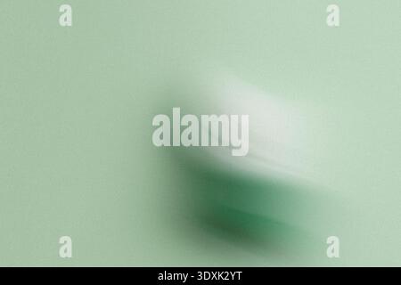 An abstract blurry image featuring shades of green and white creating a soft and dreamlike quality Stock Photo