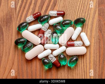 top view of many different pills on wooden table closeup Stock Photo