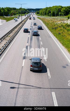 Gothenburg, Sweden - June 02 2023: Cars on a three lane highway merging into two lanes Stock Photo