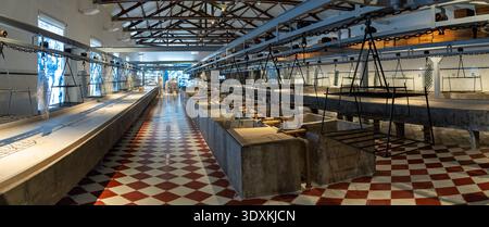 Portimao, Portugal - 2 Dec 23: Panoramic view of the cannery processing area with suspended racks and tiled floor inside the Museu de Portimão, Portim Stock Photo