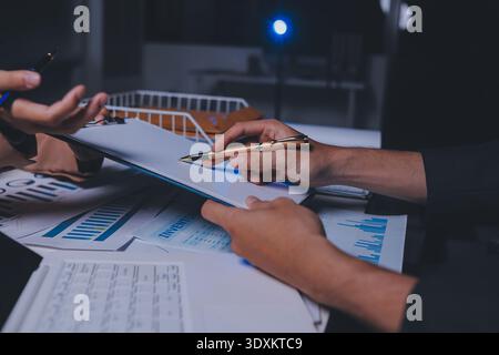 Two business people talk project strategy at office meeting room. Businessman discuss project planning with colleague at modern workplace while having Stock Photo