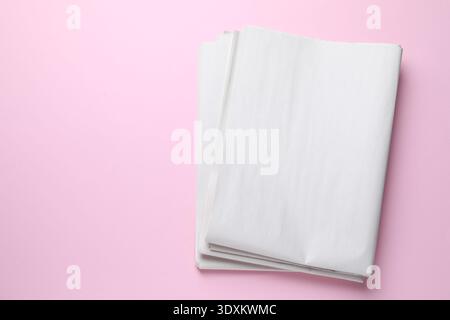 Newspapers on pink background, top view. Space for text Stock Photo