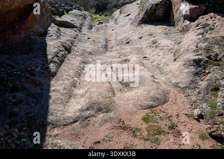 Detail of deep wheel ruts and carved grooves in sandstone bedrock at the Tiermes archaeological site in Soria, Castile and León, Spain. Stock Photo