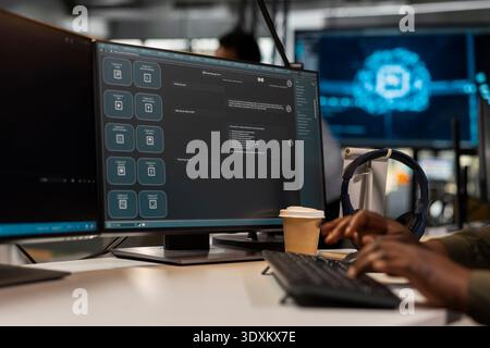 Close up of programmer at work solving tasks with AI LLM chatbot answering prompts using predictive tech. Startup IT specialist using computer to interact with large language model application Stock Photo