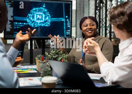 Management executives doing meeting in conference room to talk about AI solutions increasing productivity. Tech startup boardroom members discussing machine learning models development roadmap Stock Photo