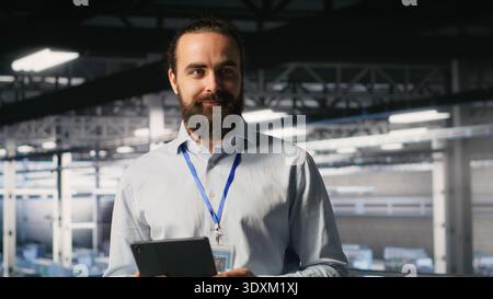 Portrait of smiling engineer in data center monitoring neural network LLM visualization. Cheerful server hub IT specialists overseeing rigs powering machine learning processes Stock Photo