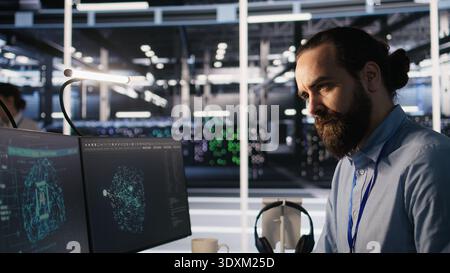 Exhausted computer scientist in server room reviewing neural network outputs, suffering from mental fatigue. Stressed data center IT expert analyzing AI LLM visualization, camera A Stock Photo