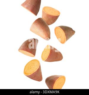 Sweet potato pieces falling against white background Stock Photo