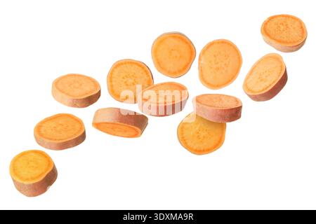 Sweet potato pieces falling against white background Stock Photo