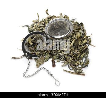 Metal tea infuser ball with chain and dry leaves isolated on white Stock Photo
