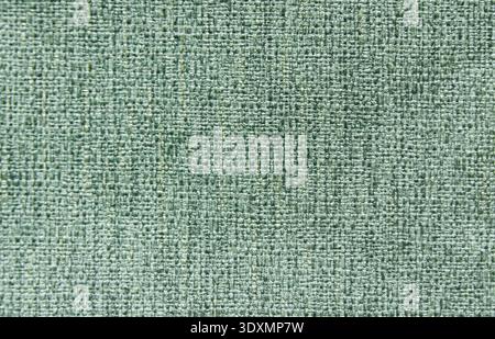 Top view of teal upholstery fabric texture. Durable woven textile background in deep green and blue tones, coarse weave pattern for furniture and inte Stock Photo