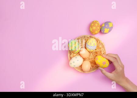Easter Celebration. Colorful decorated eggs in a nest for festive spring decor. Stock Photo