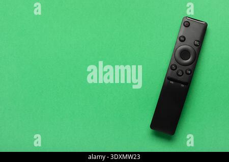 TV remote controller on green background Stock Photo