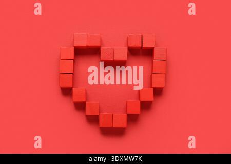 Heart made of cubes on red background Stock Photo