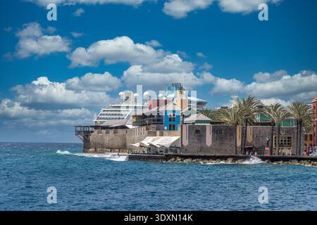View of Fort Rif a fortification turned into a shopping mall on Curacao with Cruise Ship in the background Stock Photo