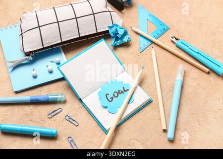 Sticky note with word GOAL and stationery on grunge background Stock Photo