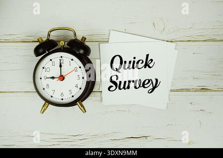 Quick Survey text with eye glasses and magnifying glass on wooden background Stock Photo
