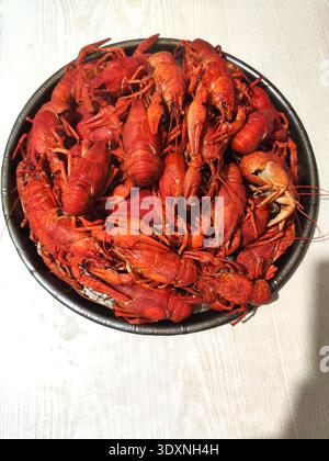 red boiled crayfish on a plate, home cooking on a forge, sea food, lobster, aquatic animals, spices Stock Photo