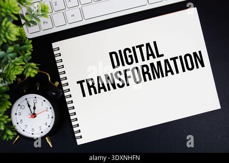 Digital Transformation text written on notepad with keyboard and alarm clock on black background Stock Photo