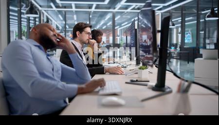Frustrated Software Developer Reviews Broken Code At Their Messy Office Desk. An Unhappy Programmer Struggles Stock Photo