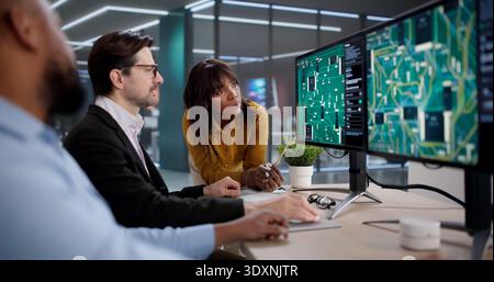 Diverse Team Collaborating On PCB Design, Developing New Technology Solutions Stock Photo