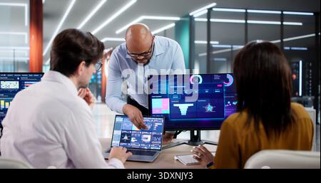 In A Modern Office, Diverse Team Collaborates Using Data Analytics Tools, Discussing Customer Behavior Predictions Stock Photo