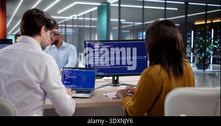 Diverse Team Of Programmers Coding Software And Designing Systems Together. An Agile Group Of Developers Meeting Stock Photo