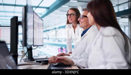 Analyzing Medical Billing Codes On Desktop Screens In Hospital Offices. Stock Photo