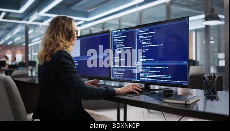Female Software Engineer Developing Back-end Programs In Secure Office Environment. Stock Photo