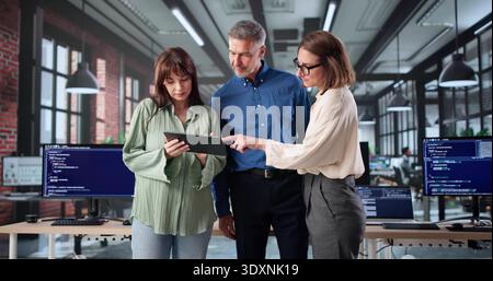 Senior Web Developers Program Code In Classroom Meeting At Night Stock Photo